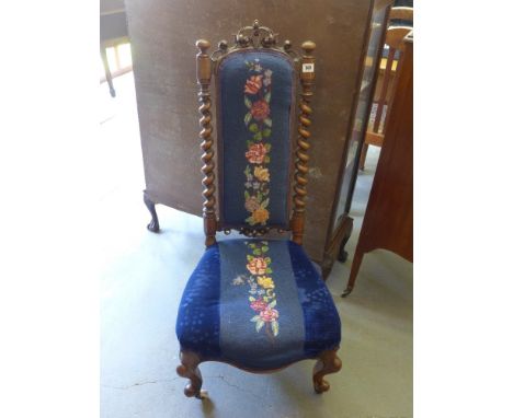 A Victorian walnut lady's chair with ornate back with carved decoration barley twist uprights, tapestry covered back and seat