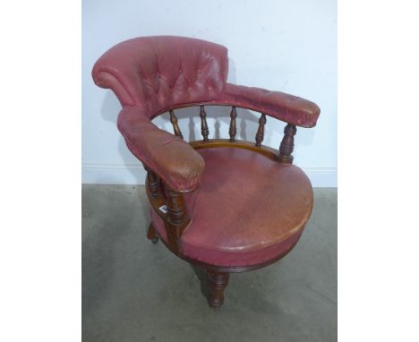 A Victorian walnut button leather upholstered Library chair with turned bobbin supports and turned front legs