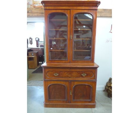 A Victorian mahogany secretaire bookcase with a two door glazed top over a fitted secretaire drawer and two panelled cupboard