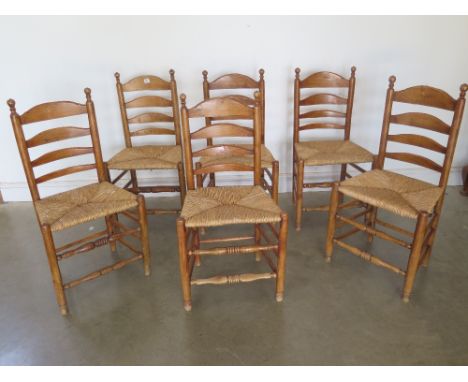 A set of six ladder back dining chairs with rush seats