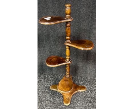 A mid century four tier paddle plant stand