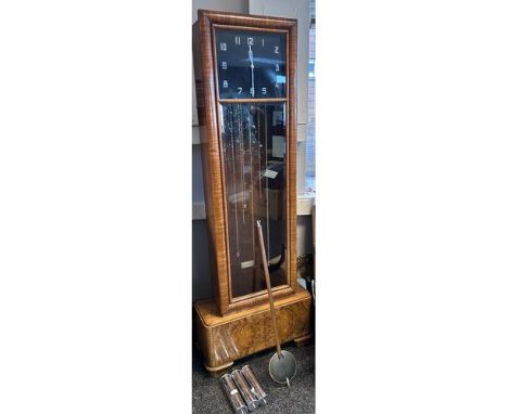 An art deco period walnut long case clock, with weights and pendulum.