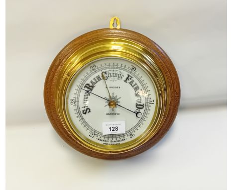 Large Late Victorian brass cased Aneroid Marine Barometer. Porcelain dial and oak plinth. Made by Rhodes of Bradford c1890.