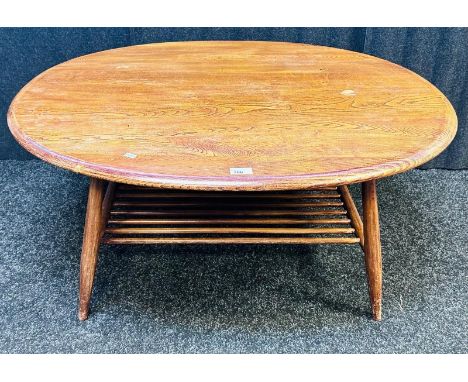 A mid-century teak coffee table raised on turned tapered legs with supporting lower spindle shelf. [44x100x83cm]