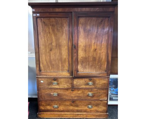 A 19th century mahogany Linen press, the moulded cornice above two cupboard doors opening to slide out shelves, the lower wit