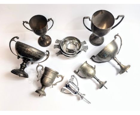 A collection of silver coloured trophies and cups.