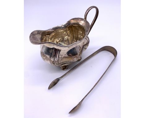 Silver cream jug together with silver sugar tongsWeight - 137g