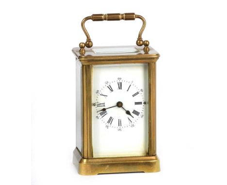 VICTORIAN BRASS CARRIAGE CLOCK WITH FOUR GLASS HANDLES AND SWING HANDLE.HEIGHT: 4.5 INCHES WIDTH: 2.5 INCHES DEPTH: 2 INCHES 