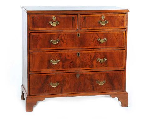 WALNUT 'TWO OVER THREE' CHEST OF DRAWERS, WITH BRASS DROP HANDLES AND BRASS ESCUTCHEONS ON BRACKET FEET.HEIGHT: 41 INCHES WID