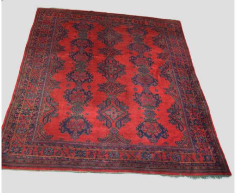 Ushak red and blue carpet, west Anatolia, circa 1930s, 13ft. 3in. X 10ft. 7in. 4.04m. X 3.23m. Some wear in places; slight da