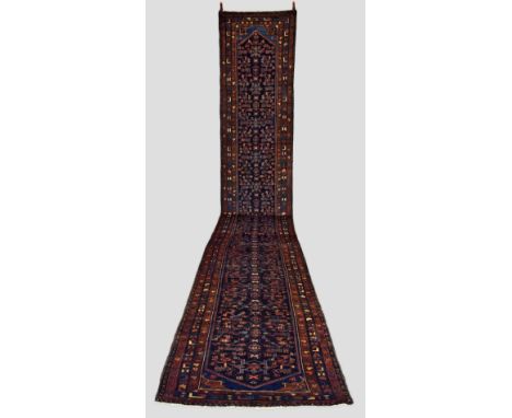 Hamadan runner, north west Persia, second half 20th century, 23ft. 2in. X 3ft. 4in. 7.07m. X 1.02m. All over herati design wi