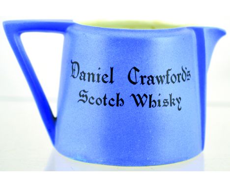 DANIEL CRAWFORD PUB JUG. 3.25ins tall, pale blue matt glaze, black transfer DANIEL CRAWFORDS/ SCOTCH WHISKY both sides. Carlt