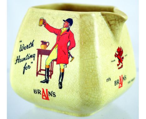 BRAINS PUB JUG. 4ins tall, white glaze, coloured transfer, huntsman pictured WORTH HUNTING FOR BRAINS both sides. Red Dragon 
