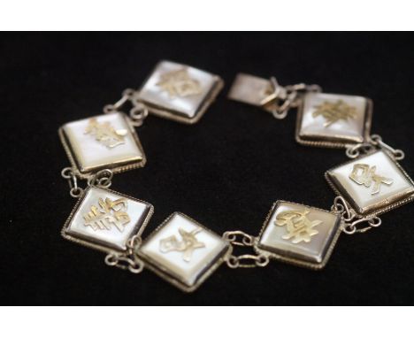 Silver Chinese bracelet with 7 links set with mother of pearl &amp; yellow metal Chinese words on each link. Stamped made in 