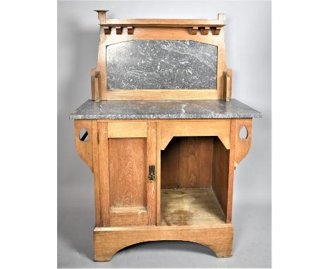 An Arts and Crafts Oak Wash Stand with Marble Top and Raised Galleried Back having Open Display adjacent to Panelled Door to 