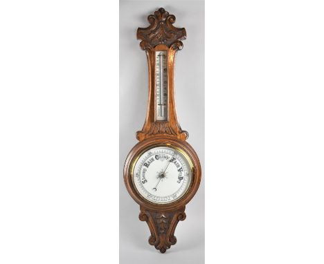 A Late 19th/Early 20th century Onion topped Wheel Barometer with Carved Decoration, One Side of Thermometer Requires refixing