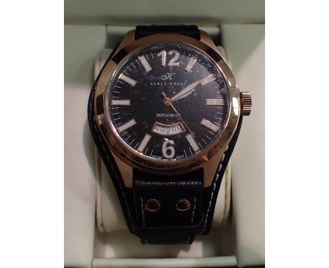Klaus-Kobec gents quartz watch with yellow metal bezel, black face and date aperture. P&amp;P Group 1 (£14+VAT for the first 