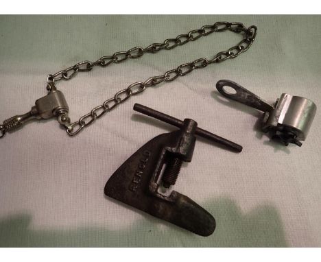 Collection of three vintage cycling accessories including a Reynolds chain riveter, Loewe odometer an a Lucas gem chain lock.