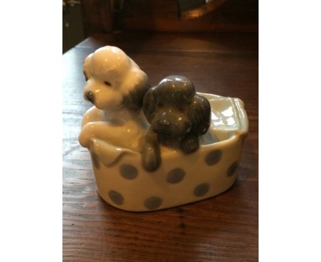 Nao Spanish porcelain by Lladro. Figure of two little dogs in a spotty&nbsp;dog bed. Nice clean condition, factory Mark to ba