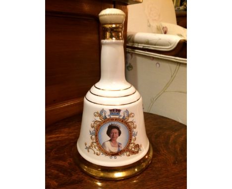 A completely unopened Wade bell shaped ceramic decanter full of Bells&nbsp;Whiskey with its plastic seal intact. 
Made to com