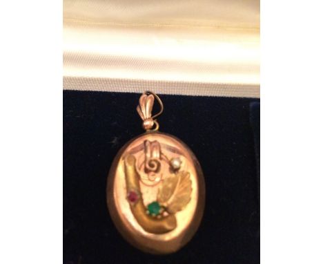 Oval shaped, gold plated, Victorian pendant with leaf and twig applied&nbsp;detail, set with an emerald and Ruby chip and one