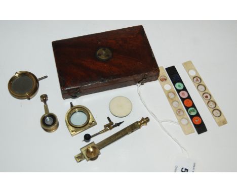 A brass cuff-type microscope, the stem engraved R. Bancks 440 Strand London with hinged folding mahogany base, 10cm wide (af)