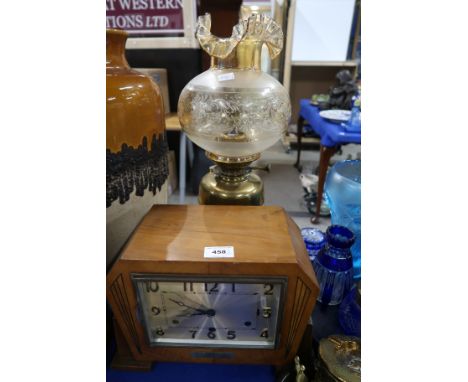 An Art Deco mantle clock and a brass oil lamp Condition Report: Available upon request