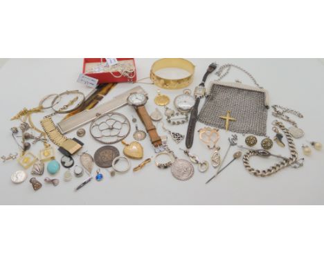 A rolled gold bangle with flower pattern set with red gems, St. Christopher, a white metal mesh purse, and other items Condit