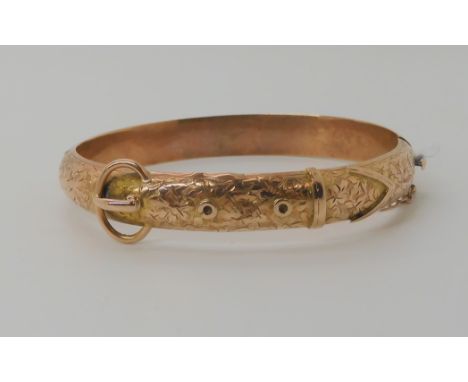 A 9ct rose gold buckle shaped bangle, hallmarked Birmingham 1864 weight 10.8gms Condition Report: Has a split seam by the buc