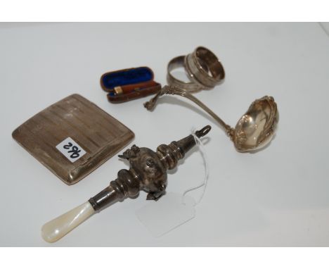 A lot comprising a silver and mother of pearl baby rattle, cigarette case, two napkin rings EP sauce ladle, amber cigarette h