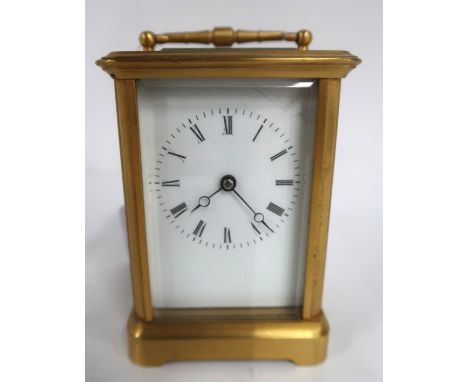 A brass cased carriage clock Condition Report: lacking handle for door and no key. 