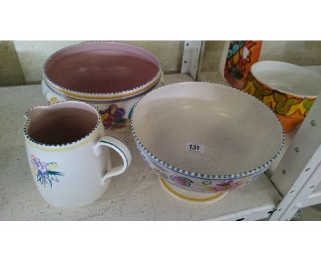 A large white bodied Poole Pottery fruit bowl decorated in the ED pattern together with a jug decorated in the PL pattern and