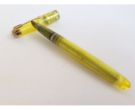 A rare Parker 51 Demonstrator with a transparent yellow barrel with a gold coloured arrow nib and grey pearl jewel cap, 14 ca