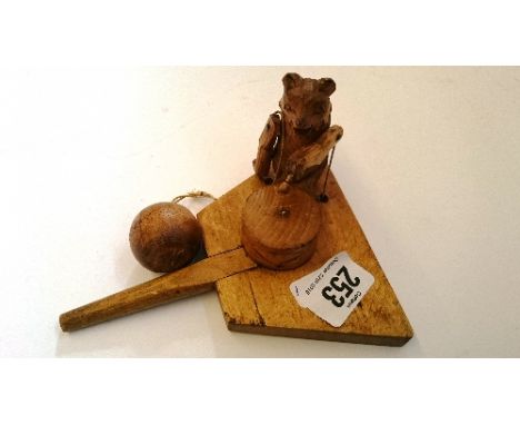 A novelty wooden automaton modelled as a Bear playing a drum operated by a swing ball.