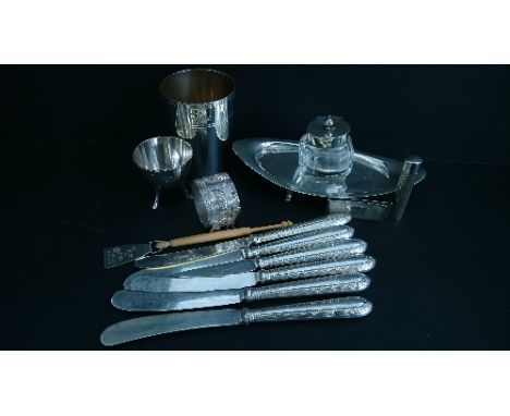 An early 20th century silver mounted glass inkwell on silver stand together with a silver beaker (111 grams), silver egg cup,
