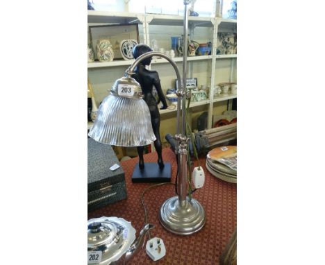 An Art Deco chrome plated metal lamp base with ribbed glass shade.