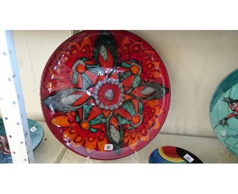 A massive Poole Pottery style platter by Angela Wyburgh decorated in a Delphis style abstract floral design (19.5" diameter).