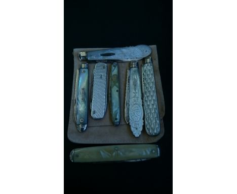 Four mother of pearl and silver bladed fruit knives together with an engine turned silver cased pen knife and two others.