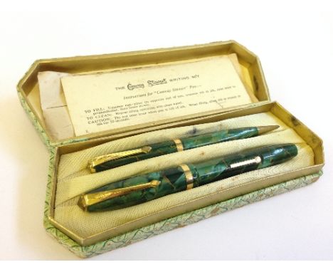 A boxed Conway Stewart 84 fountain pen and pencil set in a green pearl pattern with 14 carat gold nib and original instructio