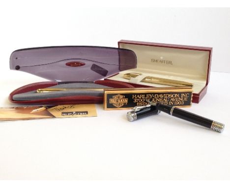 A boxed Sheaffer Imperial in a gold plated style barleycorn pattern together with a boxed Harley Davidson fountain pen and an