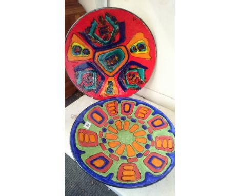 A Poole Zone pottery dish decorated in bright enamel colours in a geometric design (16") together with another. (H45, H44)