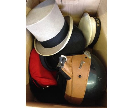 A box of hats including a mid 20th century motorcycle helmet.
