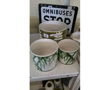 Three Poole Pottery plant pots decorated with bamboo and leaf designs.
