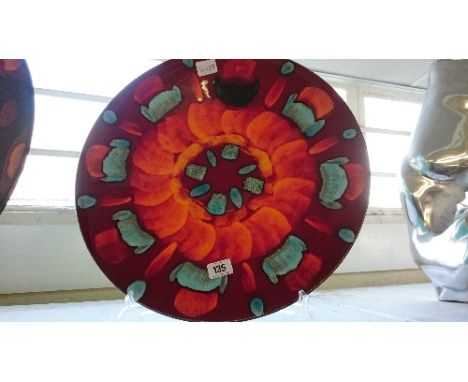 A Poole Pottery Living Glaze charger decorated in the Volcano design.
