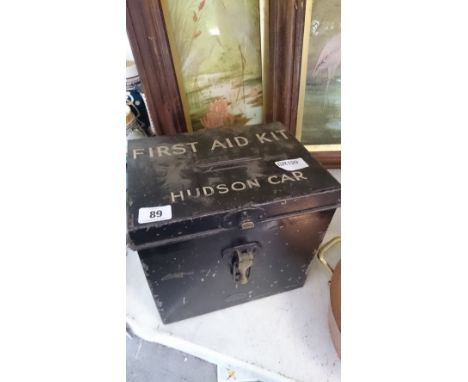An early 20th century black painted metal first aid kit and contents (contents later).