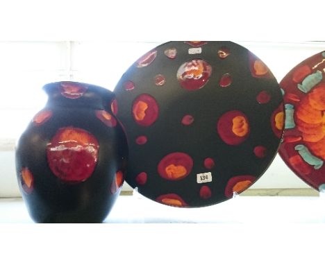 A Poole Pottery Living Glaze charger decorated in the Galaxy design together with a matching vase.