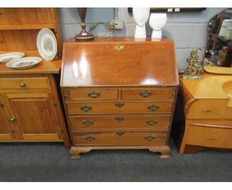 A mahogany reproduction bureau in the 18th Century style. Two short over three graduating long drawers. 104cm x 95cm x 54cm 