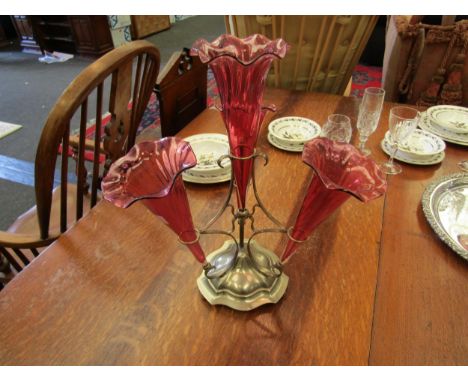 An early 20th Century plated table epergne with four cranberry trumpets.  Inscription to base 