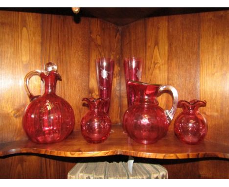 A selection of Victorian and later cranberry glass including decanter, jugs and glasses 