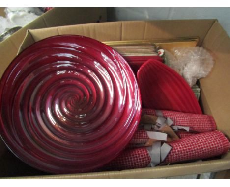 A box of miscellaneous place mats, red ceramic and glass dishes together with a box of miscellaneous CD's and DVD's  includin